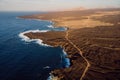 Aerial view of lava cliffs and ocean with warm sunset. Lanzarote, Canary Islands