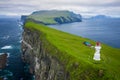 Aerial view of lighthouse at Mykines island in Faroe Islands, North Atlantic Ocean. Photo made by drone from above. Nordic natural Royalty Free Stock Photo