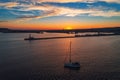 Aerial view of lighthouse and sail boat at sunset in Varna, Bulgaria.
