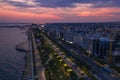 Aerial view of Limassol promenade or embankment with alley and buildings in Cyprus at night. Drone photo of