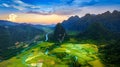Aerial view of limestone mountains and rice field at sunset in Vang vieng, Laos