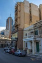 Aerial view of a line of parked cars along the side of a road on a sunny day in Malta