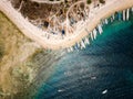 Aerial view of lines of wooden tourist boats on a sandy beach of a tropical island Royalty Free Stock Photo