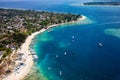 Aerial view of lines of wooden tourist boats on a sandy beach of a tropical island Royalty Free Stock Photo