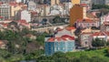 Aerial view of Lisbon skyline with road and aqueduct. Historic buildings near Campo de Ourique district with green trees