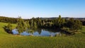 Aerial view of a little lake and trees surrounding, in italian Appennini hills Royalty Free Stock Photo