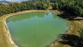 Aerial view of a little lake and trees surrounding, in italian Appennini hills Royalty Free Stock Photo