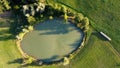 Aerial view of a little lake and trees surrounding, in italian Appennini hills Royalty Free Stock Photo