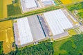 Aerial view of the logistics park with warehouse, loading hub and many semi trucks with cargo trailers standing at the ramps Royalty Free Stock Photo