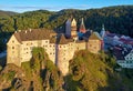 Aerial view of Loket Castle, Burg Elbogen, gothic style castle on rocky cliff above river Ohre. Royalty Free Stock Photo