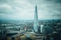 Aerial view of London with The Shard skyscraper and Thames river at sunset with grey clouds in the sky. Royalty Free Stock Photo