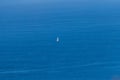 Aerial view of the lonely boat in the middle of the blue calm ocean Royalty Free Stock Photo