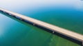 Aerial view of a long highway bridge above a river.