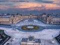 Aerial view of Louvre museum in Paris, France with glass pyramid and dramatic sunset sky. Royalty Free Stock Photo