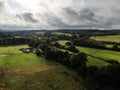 Aerial view of lovely countryside with cloud and sunshine and white cottage