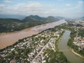 Aerial view of Luang Prabang and surrounding lush mountains of Laos. Nam Kahn River, a tributary of the Mekong River, flows