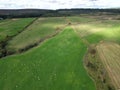 Aerial view of a lush green meadow with hay bales Royalty Free Stock Photo