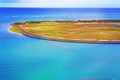 Aerial view of a lush island set against an blue ocean