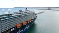 Aerial view of a luxury cruise docked in the port of Alicante, Spain.