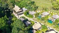 Aerial view of luxury hotel with villas and pool in tropical jungle and palm trees. Luxurious villa, pavilion in forest