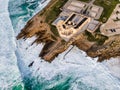 Aerial view of a luxury otel resort on the rocky promontory in South Portugal, view of a building standing on te cliffs along the
