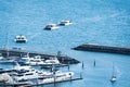 Aerial view of luxury private motor yachts and happy travelers are underway on the tropical sea and sailing to marina port at Royalty Free Stock Photo