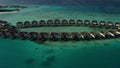 Aerial view of luxury villas over water on blue lagoon