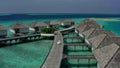 Aerial view of luxury villas over water on blue lagoon