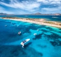 Aerial view of luxury yachts on blue sea and sandy beach