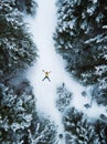 Aerial view of the lying man in winter forest Royalty Free Stock Photo