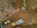 Aerial view machinery and heavy-duty equipments at large construction site of excavator, bulldozer, dump truck, digger