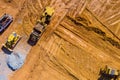 Aerial view machinery and heavy-duty equipments at large construction site of excavator, bulldozer, dump truck, digger Royalty Free Stock Photo