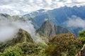 Aerial view of Machu Picchu Inca citadel in the clouds, located on a mountain ridge above the Sacred Valley Royalty Free Stock Photo