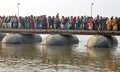 Thousands of Hindu devotees crossing the pontoon bridges over the Ganges River at Maha Kumbh Mela festival Royalty Free Stock Photo