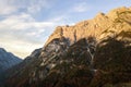 Aerial view of majestic european Alps mountains covered in evergreen pine forest in autumn