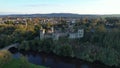 Aerial view of majestic Lismore Castle in County Waterford, Ireland, bathed in the golden glow of the setting sun