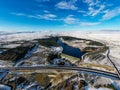 Aerial view of a major road running through a snowy landscape Royalty Free Stock Photo