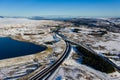 Aerial view of a major road running through a snowy landscape