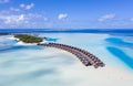 Aerial view of the Maldivian island with tourist bungalows on a coral atoll in the Indian Ocean Royalty Free Stock Photo