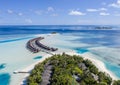 Aerial view of the Maldivian island with tourist bungalows on a coral atoll in the Indian Ocean Royalty Free Stock Photo