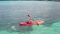 Aerial view of man kayaking in crystal clear sea water near Koh Kra island in Thailand