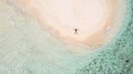 Aerial View Of Man Lying On Sandy Beach Near Turquoise Sea In Kri Island, Raja Ampat. Guy Resting On Wild Resort In Papua,