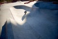 Aerial view of man, male roller skater on rollerblades training at modern skate park, outdoors. Action, motion, skills