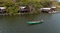 Aerial view of a man sailing a boat near the Wag Hill lodge and spa on the shore of Lake Victoria Royalty Free Stock Photo