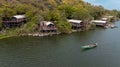 Aerial view of a man sailing a boat near the Wag Hill lodge and spa on the shore of Lake Victoria Royalty Free Stock Photo