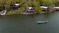 Aerial view of a man sailing a boat near the Wag Hill lodge and spa on the shore of Lake Victoria Royalty Free Stock Photo