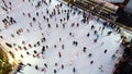 Aerial View many people skating on open-air ice rink winter New Year Christmas