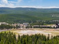 Aerial view of many people waiting for the Old Faithful geyser hot water eruptions