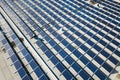 Aerial view of many photo voltaic solar panels mounted of industrial building roof Royalty Free Stock Photo