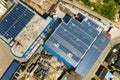 Aerial view of many photo voltaic solar panels mounted of industrial building roof Royalty Free Stock Photo